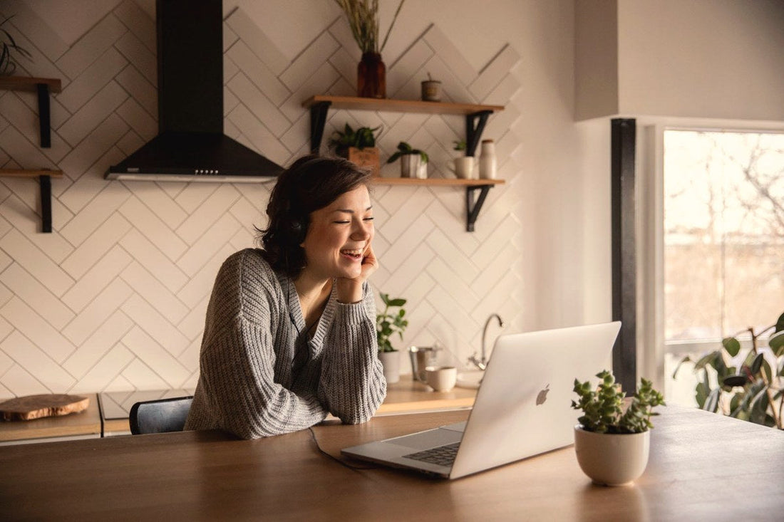 Woman smiling during a video call on her laptop at home, a long distance love story
