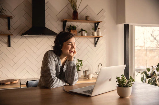 Woman smiling during a video call on her laptop at home, a long distance love story
