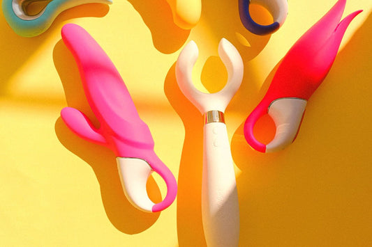 Top view of colorful silicone vibrators on a yellow background, vibration types and settings compared